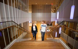Two people walking up stairs.